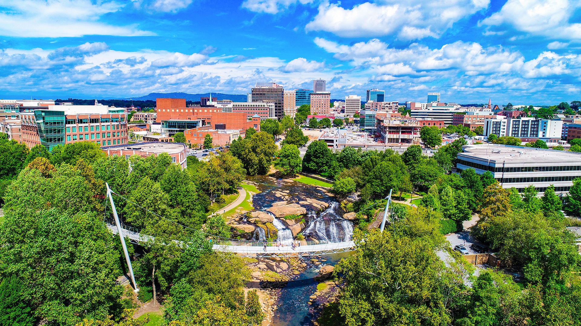 an aerial view of a city with a waterfall